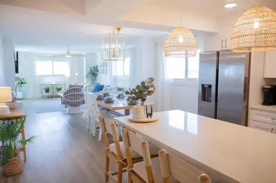 a kitchen and living room with a table and chairs at Regency 501 in Panama City Beach