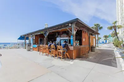 people sitting at a bar at the beach at Regency 501 in Panama City Beach