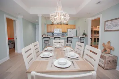 a dining room and kitchen with a table and chairs at Ocean Ritz 1501 in Panama City Beach