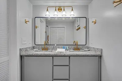 a bathroom with two sinks and a large mirror at Fontainebleau 428 in Panama City Beach