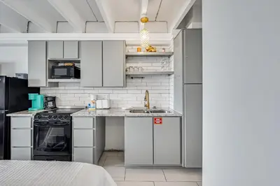 a kitchen with white cabinets and a counter top at Fontainebleau 428 in Panama City Beach