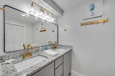a bathroom with two sinks and a large mirror at Fontainebleau 428 in Panama City Beach