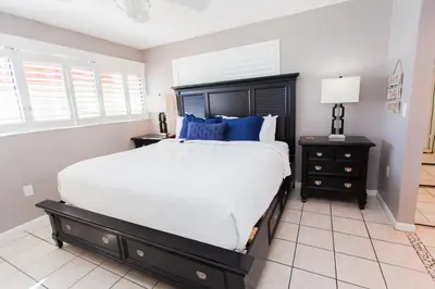 a bedroom with a large bed with blue pillows at Summerhouse 1005a in Panama City Beach