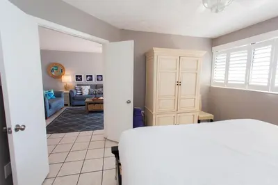 a bedroom with a bed and a living room at Summerhouse 1005a in Panama City Beach