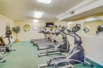 a row of exercise bikes in a gym at Walk to Pools and Outdoor Bar! Oceanfront PCB Gem in Panama City Beach