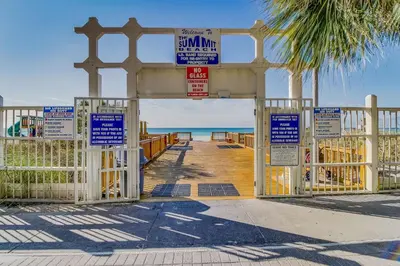 a gate at the beach with signs on it at Walk to Pools and Outdoor Bar! Oceanfront PCB Gem in Panama City Beach