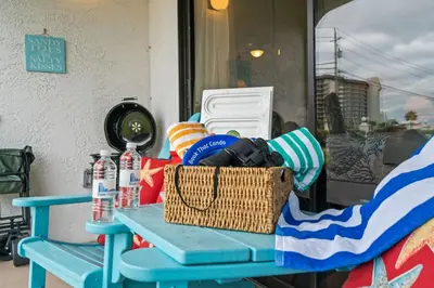 a blue table with a basket and water bottles on it at Edgewater Golf Villas #3105 by Book That Condo in Panama City Beach