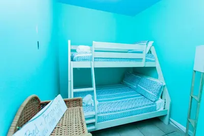 a room with bunk beds in a blue room at Shores of Panama 2220 in Panama City Beach