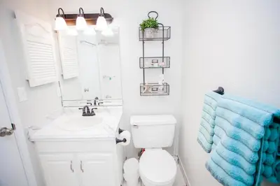 a bathroom with a toilet and a sink and a mirror at Mariner West 508 in Panama City Beach