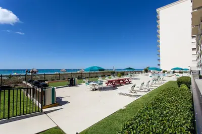 a view of the beach from the balcony of a resort at Mariner West 508 in Panama City Beach