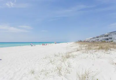 a beach with people on it and the ocean at Palms A4 Studio in Panama City Beach