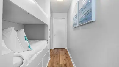 a small room with a bed and a painting on the wall at West End Coastal Escape Renovated 1BR Condo w Pool Beach Access 72 in Panama City Beach