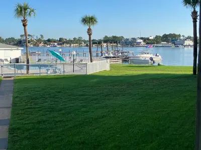 a park with palm trees and a body of water at Make Your Getaway in Panama City Beach