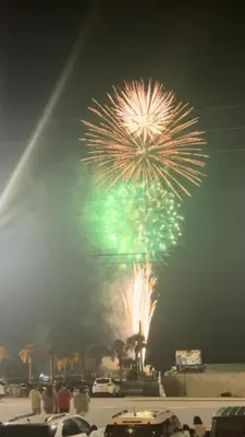a fireworks display in a parking lot with people watching at Make Your Getaway in Panama City Beach