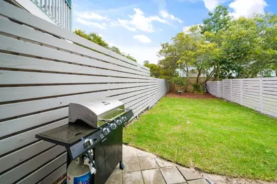 a barbecue grill on the side of a house at 30A Hideaway l Ocean Views l Across street from beach l Rosemary Beach in Inlet Beach