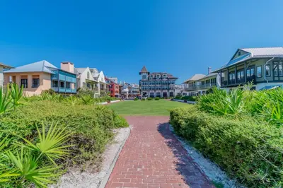 a brick path through a residential neighborhood with houses at 30A Hideaway l Ocean Views l Across street from beach l Rosemary Beach in Inlet Beach