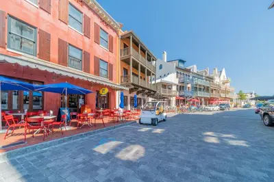 a street with tables and chairs and a food cart at 30A Hideaway l Ocean Views l Across street from beach l Rosemary Beach in Inlet Beach