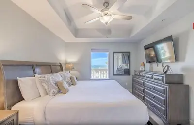 a bedroom with a bed and a ceiling fan at Calypso 3-1006 by Emerald Coast Retreats in Panama City Beach