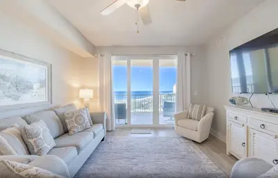 a living room with a couch and a table at Calypso 3-1006 by Emerald Coast Retreats in Panama City Beach