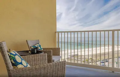 a balcony with chairs and a view of the beach at Calypso 3-1006 by Emerald Coast Retreats in Panama City Beach