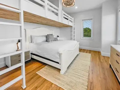 a white bedroom with a bunk bed and a window at Summer Wind l Ocean Views, Steps to Beach, Private Pool and Jacuzzi, Golf Cart, Bikes, Ample Parking in Seagrove Beach
