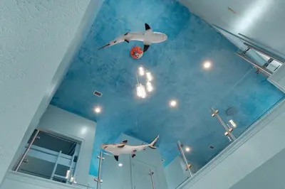 a room with a ceiling with fake sharks and a ball at Aqua! Under The Sea! - Beach Access! - Pool! in Seacrest