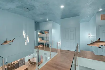 a room with a staircase with a dolphin on the wall at Aqua! Under The Sea! - Beach Access! - Pool! in Seacrest