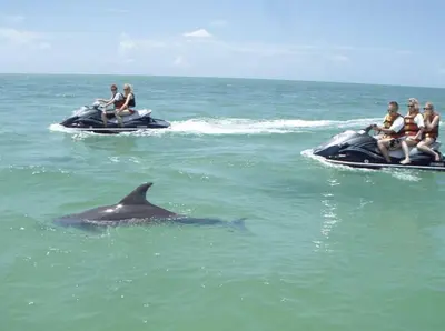 a group of people riding on jet skis in the water at Aqua! Under The Sea! - Beach Access! - Pool! in Seacrest