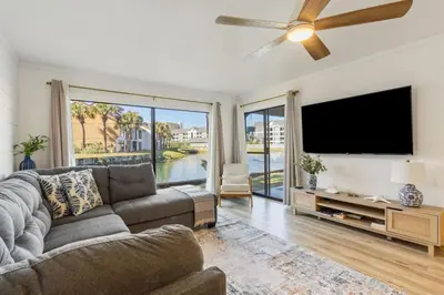 a living room with a couch and a flat screen tv at Edgewater Resort Villa Beach, Pools,Golf in Panama City Beach