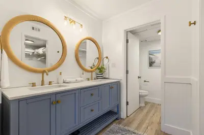 a bathroom with a blue vanity and two mirrors at Edgewater Resort Villa Beach, Pools,Golf in Panama City Beach