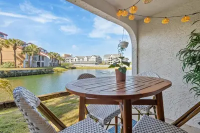 a table and chairs on a balcony with a view of the water at Edgewater Resort Villa Beach, Pools,Golf in Panama City Beach
