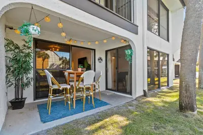 a patio with a table and chairs on a house at Edgewater Resort Villa Beach, Pools,Golf in Panama City Beach