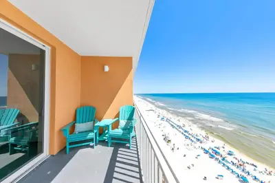 a balcony with blue chairs and the beach at Beachfront Condo in Panama City Beach! in Panama City Beach