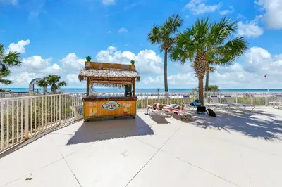 a lifeguard station on a beach with palm trees at Beachfront Condo in Panama City Beach! in Panama City Beach