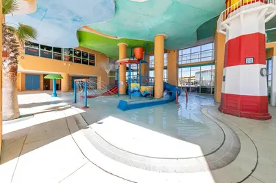 a water park with a water slide in a building at Beachfront Condo in Panama City Beach! in Panama City Beach