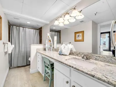 a bathroom with a sink and a large mirror at Watercrest 110 in Panama City Beach