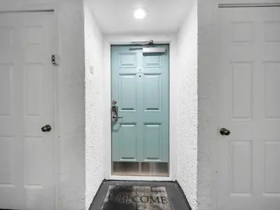 a blue door in the middle of two white doors at Watercrest 110 in Panama City Beach
