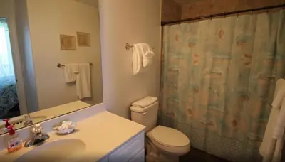 a bathroom with a toilet and a shower curtain at Emerald Isle 1406 by Emerald Coast Retreats in Panama City Beach