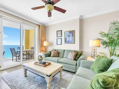 a living room with a couch and a table at Emerald Isle 1406 by Emerald Coast Retreats in Panama City Beach