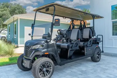 a golf cart parked in front of a house at Luxe 8BR with Pool, Golf Cart - 2 Min to Beach in Santa Rosa Beach