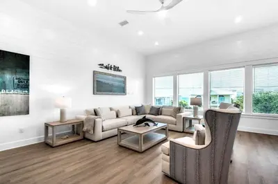 a white living room with a couch and chairs at NEW- Horizon! Private Beach - Golf Cart - Pool in Santa Rosa Beach