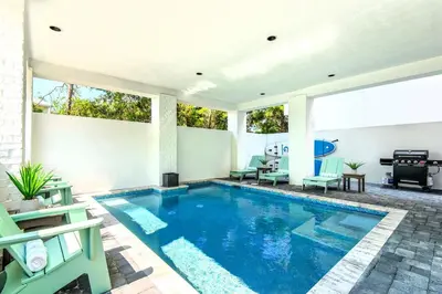 a swimming pool in the middle of a house at NEW- Horizon! Private Beach - Golf Cart - Pool in Santa Rosa Beach