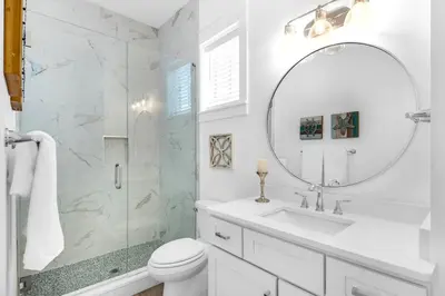 a white bathroom with a sink and a mirror at NEW- Horizon! Private Beach - Golf Cart - Pool in Santa Rosa Beach