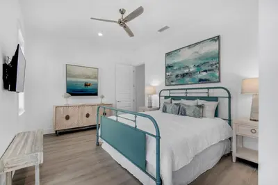 a bedroom with a bed and a ceiling fan at NEW- Horizon! Private Beach - Golf Cart - Pool in Santa Rosa Beach
