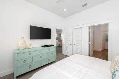 a bedroom with a green dresser with a television on it at NEW! Symphony! Sleeps 18 - Pool - Golf Cart in Santa Rosa Beach