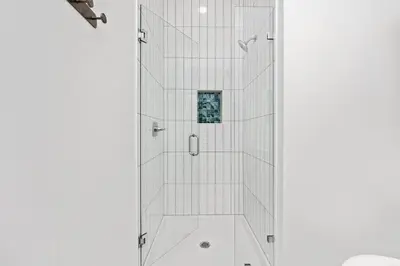 a shower with a glass door in a bathroom at NEW! Symphony! Sleeps 18 - Pool - Golf Cart in Santa Rosa Beach