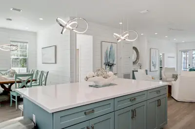 a kitchen with a island with a white counter top at NEW! Symphony! Sleeps 18 - Pool - Golf Cart in Santa Rosa Beach