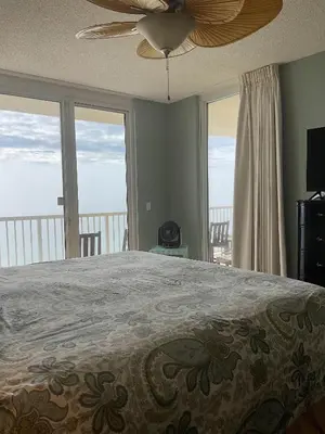 a bedroom with a bed and a ceiling fan at Peaks and Tide - Majestic Beach Resort in Panama City Beach