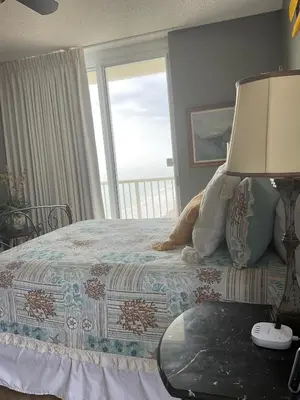 a bedroom with a bed with a view of the ocean at Peaks and Tide - Majestic Beach Resort in Panama City Beach