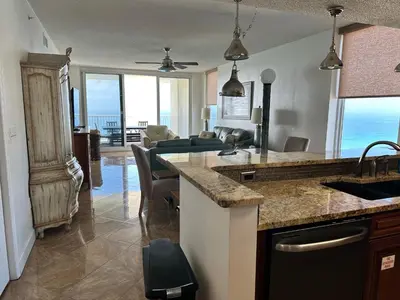 a kitchen and living room with a view of the ocean at Peaks and Tide - Majestic Beach Resort in Panama City Beach